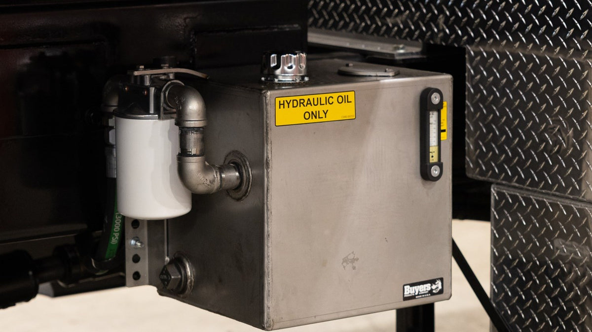 Stainless steel hydraulic reservoir with return line filter mounted on a work truck - Buyers Products